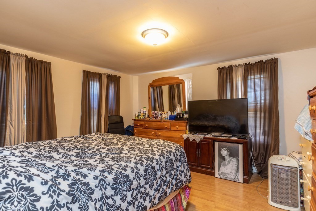 48 West Broadway Gardner, MA 01440 - Photo 12 of 21 a bedroom with a bed and a flat screen tv