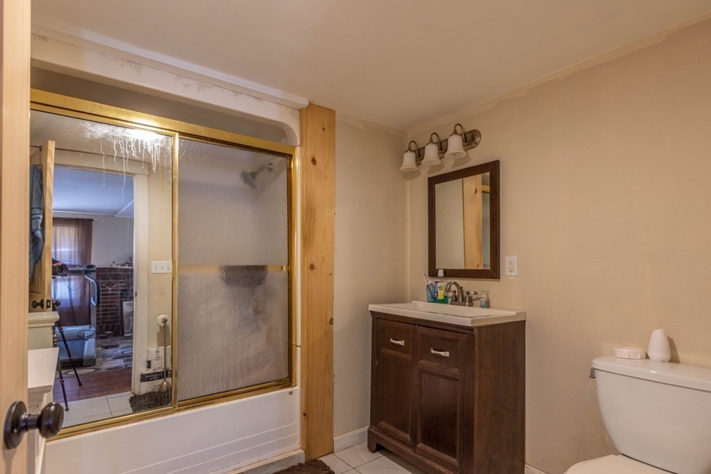 48 West Broadway Gardner, MA 01440 - Photo 13 of 21 a bathroom with a toilet sink and mirror