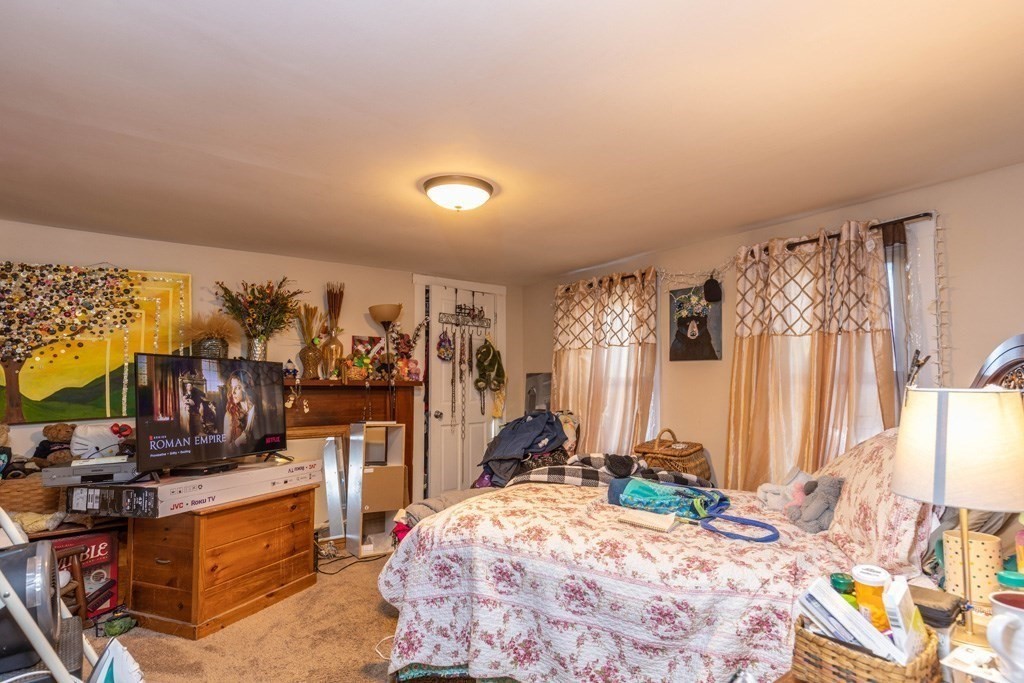 48 West Broadway Gardner, MA 01440 - Photo 17 of 21 a bed room with a bed and a couch