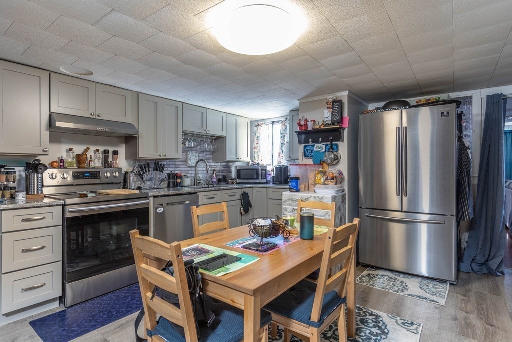 48 West Broadway Gardner, MA 01440 - Photo 3 of 21 a kitchen with stainless steel appliances granite countertop a refrigerator and a stove top oven