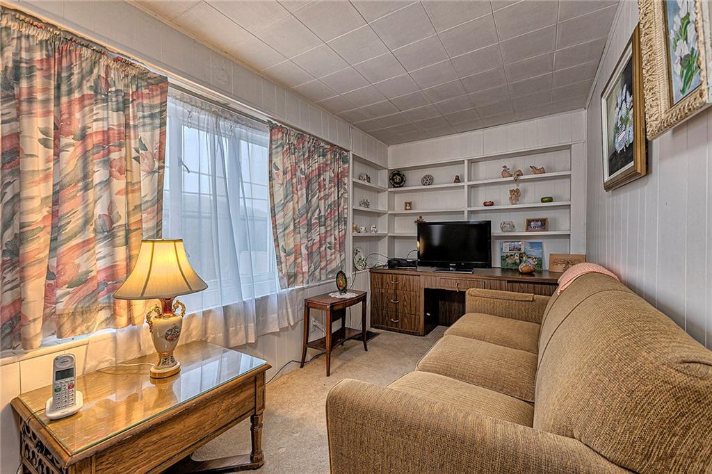 111 Dixonville Road Clymer, PA 15728 - Photo 14 of 27 a living room with furniture a flat screen tv and a fireplace