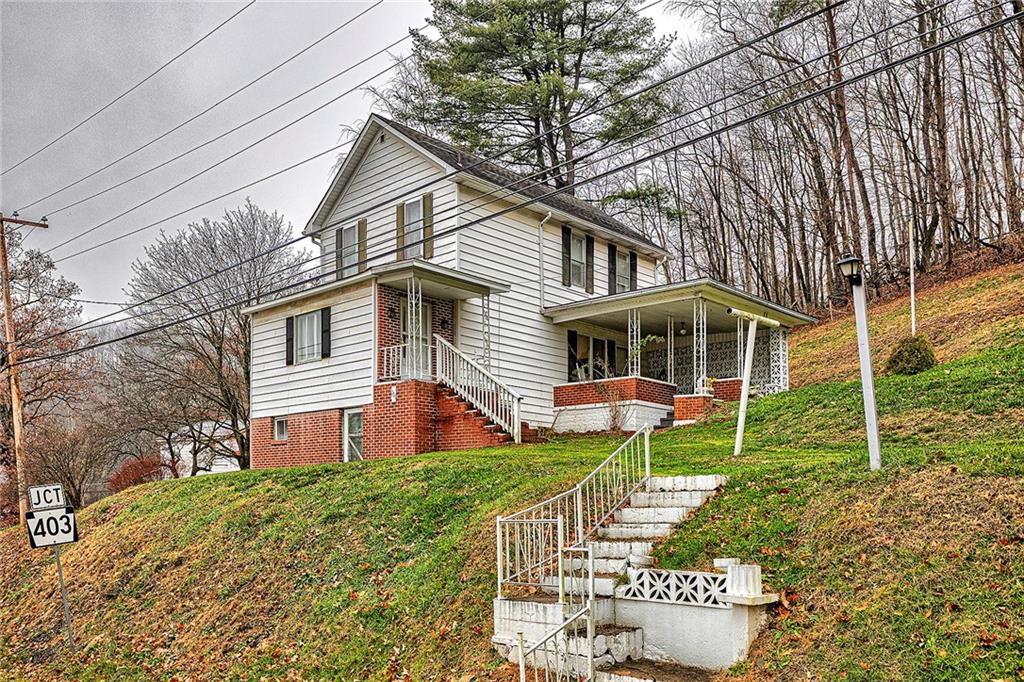 111 Dixonville Road Clymer, PA 15728 - Photo 2 of 27 a front view of a house with a yard and porch