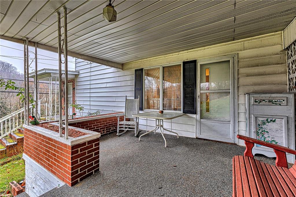 111 Dixonville Road Clymer, PA 15728 - Photo 4 of 27 a outdoor space with the couches and dining table with the garden view