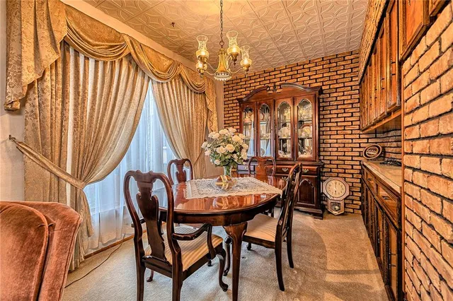 a dining room with furniture and a chandelier