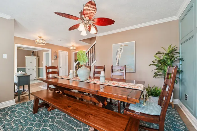 a room with furniture pool table and paintings on the wall