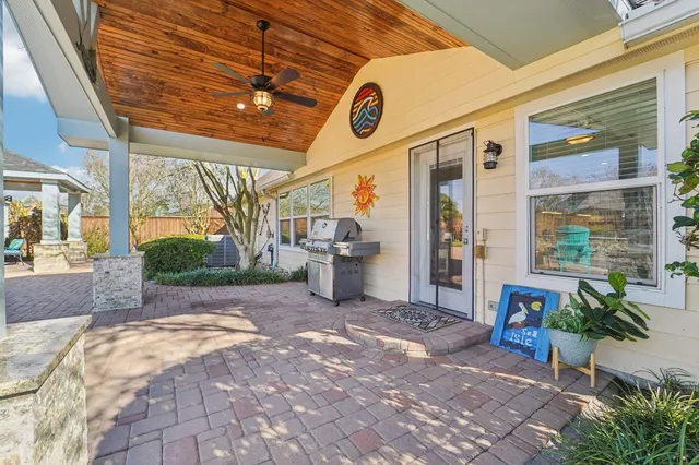 a view of a patio with a table and chairs and potted plants