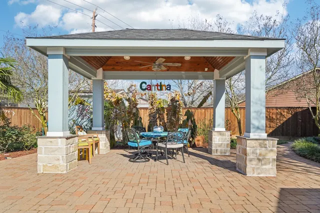a view of a patio with table and chairs potted plants with wooden floor