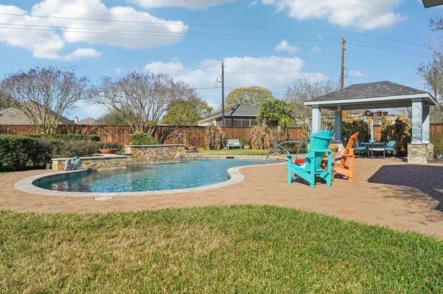 a view of outdoor space with swimming pool and seating