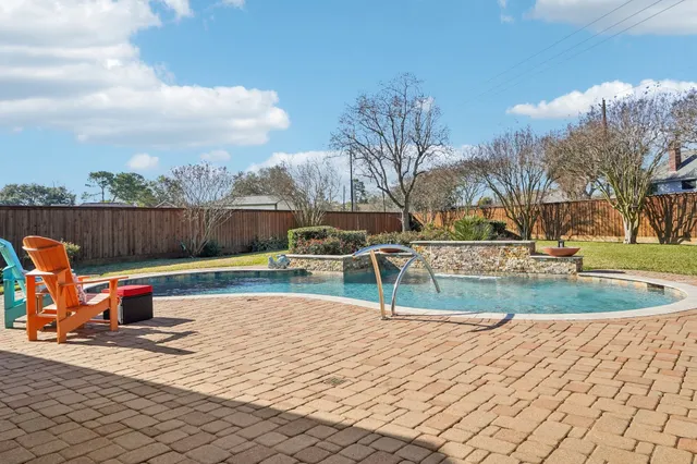 a view of a swimming pool with a lounge chair