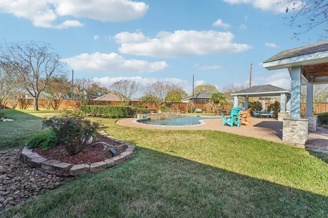 a view of a lake with a house swimming pool outdoor seating and entertaining space
