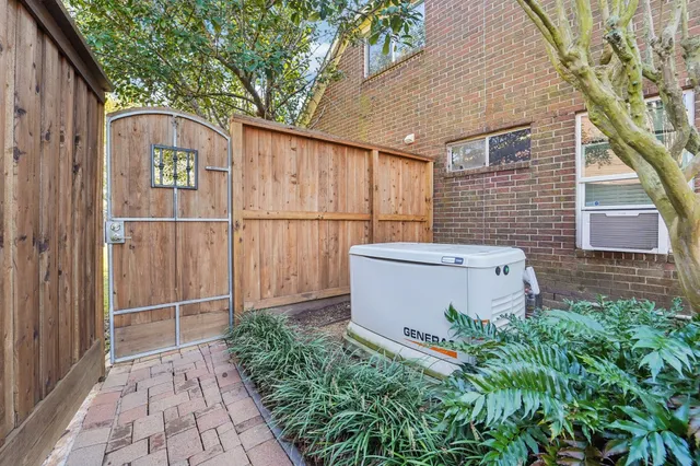 a white house with tree in front of it