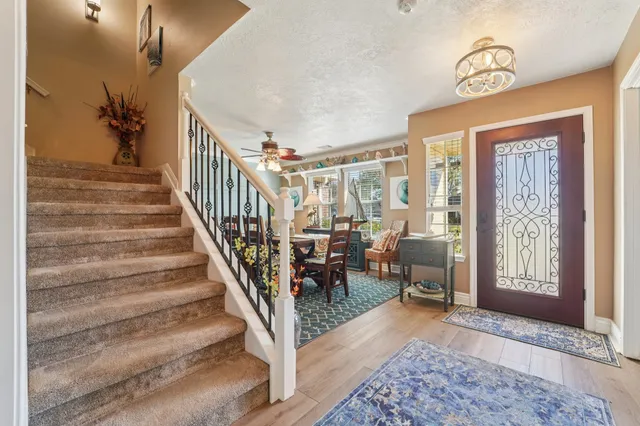 a view of entryway and hall with wooden floor