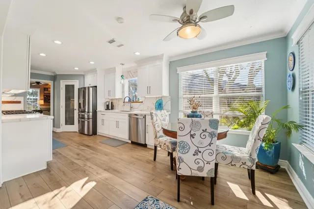 a living room with dining table furniture and a large window