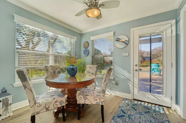 a dining room with furniture and a window