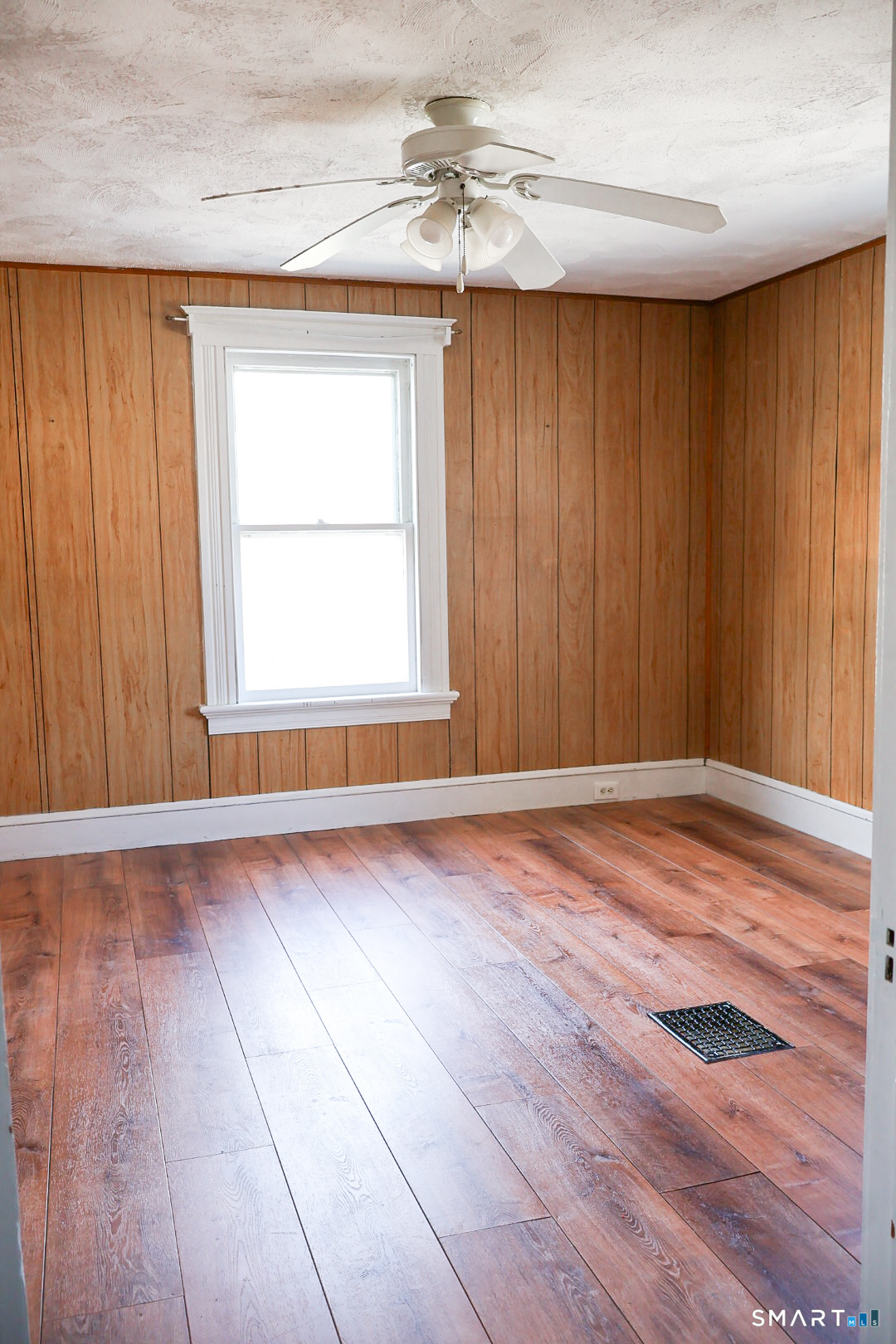66 Forest Court Torrington, CT 06790 - Photo 14 of 18 an empty room with wooden floor and windows