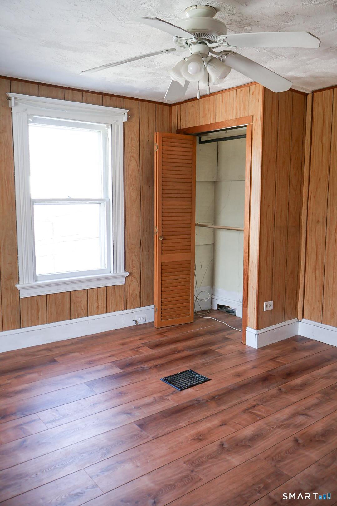 66 Forest Court Torrington, CT 06790 - Photo 15 of 18 a view of an empty room with wooden floor and a window
