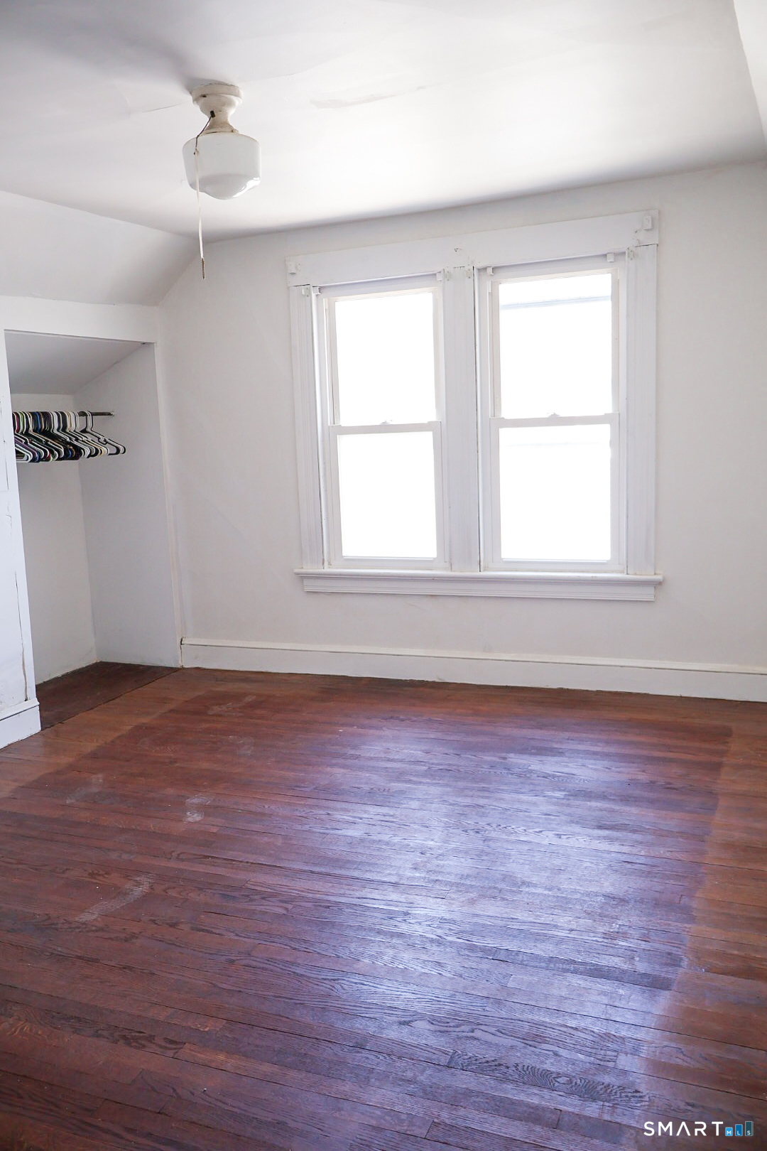 66 Forest Court Torrington, CT 06790 - Photo 16 of 18 an empty room with wooden floor and windows