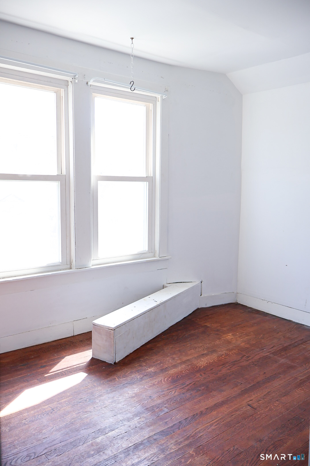 66 Forest Court Torrington, CT 06790 - Photo 17 of 18 a view of an empty room with wooden floor and a window