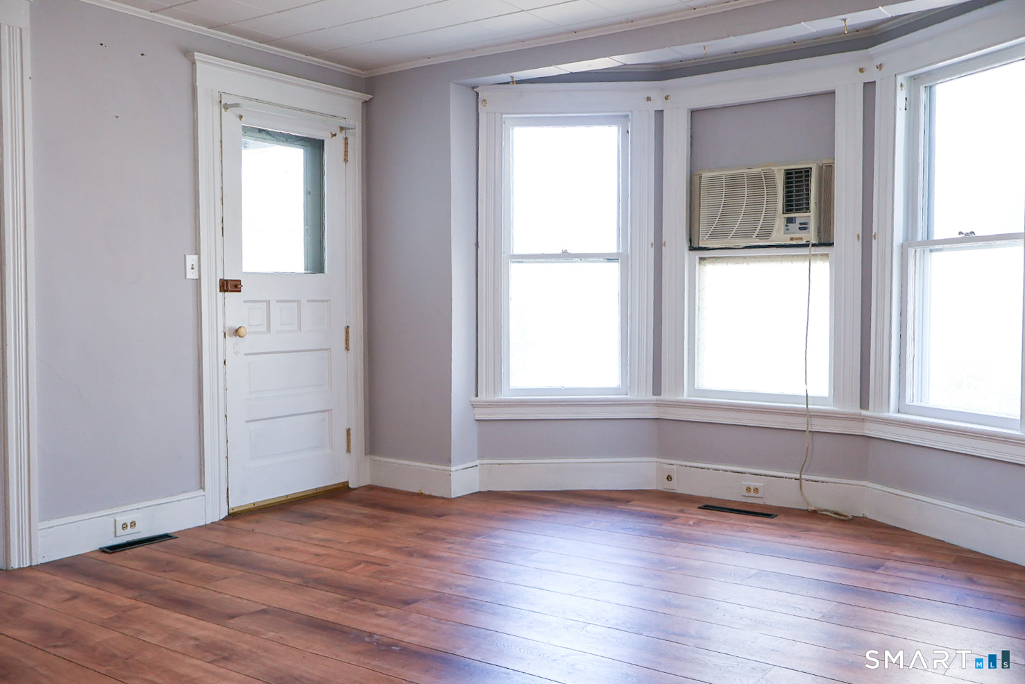 66 Forest Court Torrington, CT 06790 - Photo 8 of 18 an empty room with wooden floor and windows