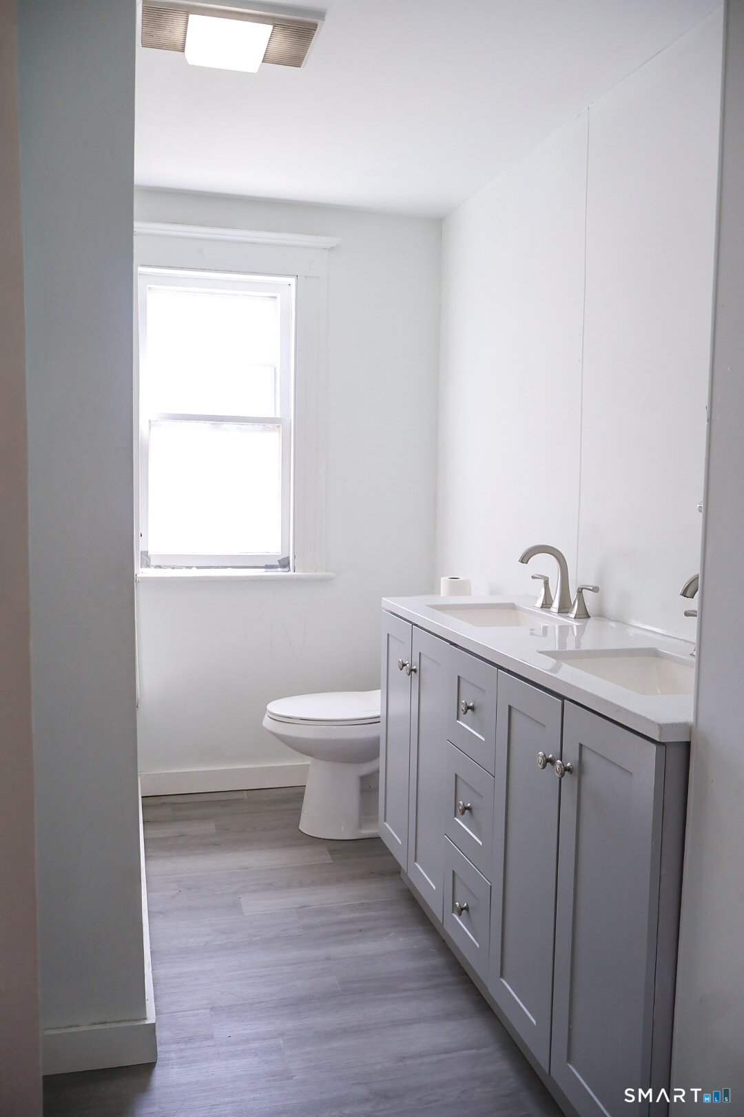 66 Forest Court Torrington, CT 06790 - Photo 9 of 18 a spacious bathroom with a toilet sink and mirror