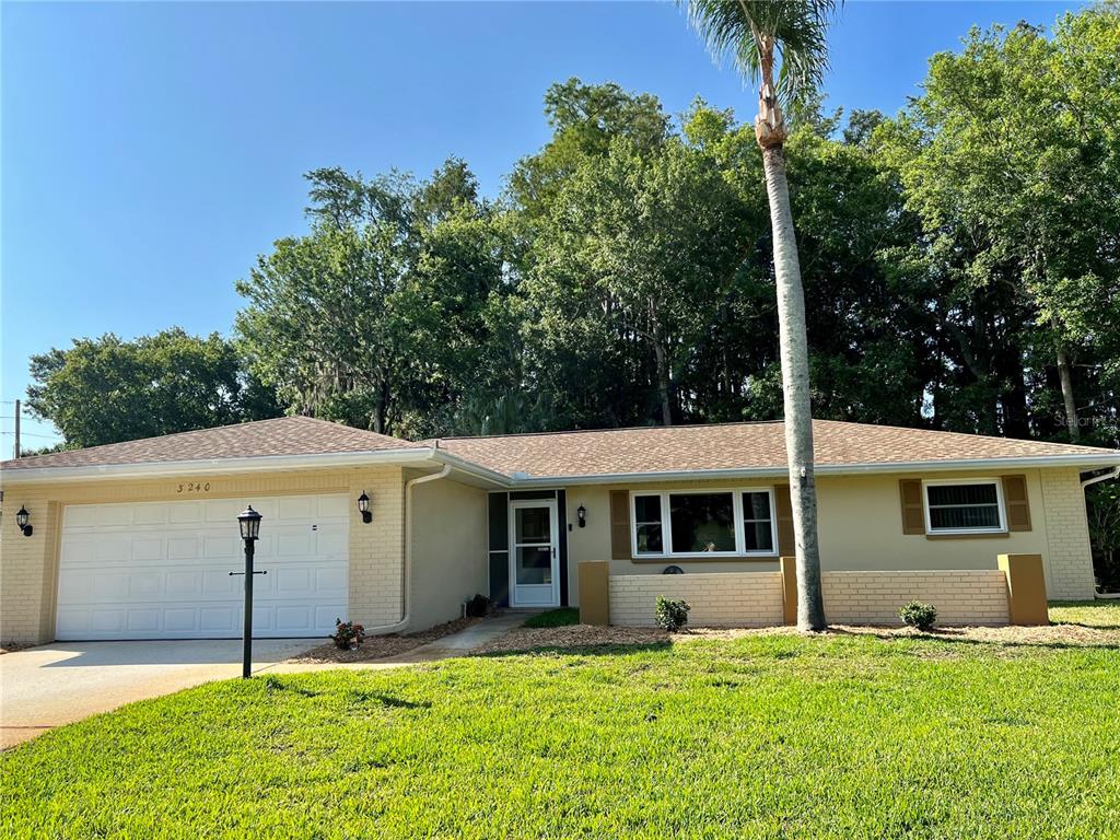 3240 Sand Key Drive Palm Harbor, FL 34684 - Photo 1 of 39 a view of a house with a yard and tree s