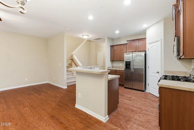 a view of a room with wooden floor and chandelier