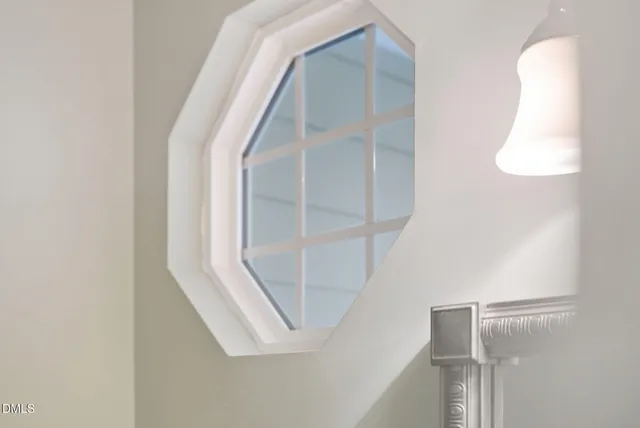 a view of staircase with railing and white walls