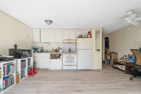 a utility room with cabinets washer and dryer