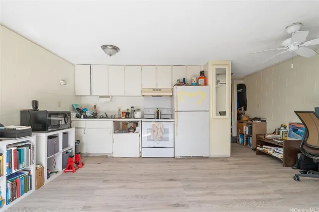 a utility room with cabinets washer and dryer