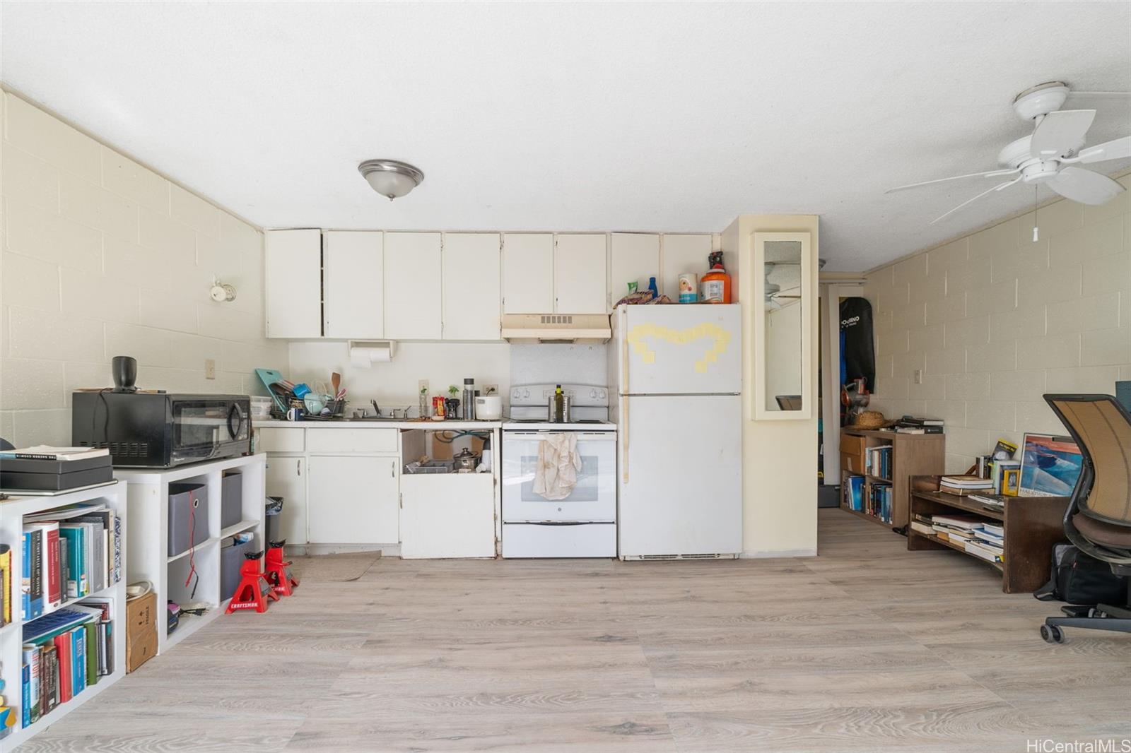 1025 Maunaihi Place, Unit 206 Honolulu, HI 96822 - Photo 4 of 9 a view of kitchen with furniture and wooden floor