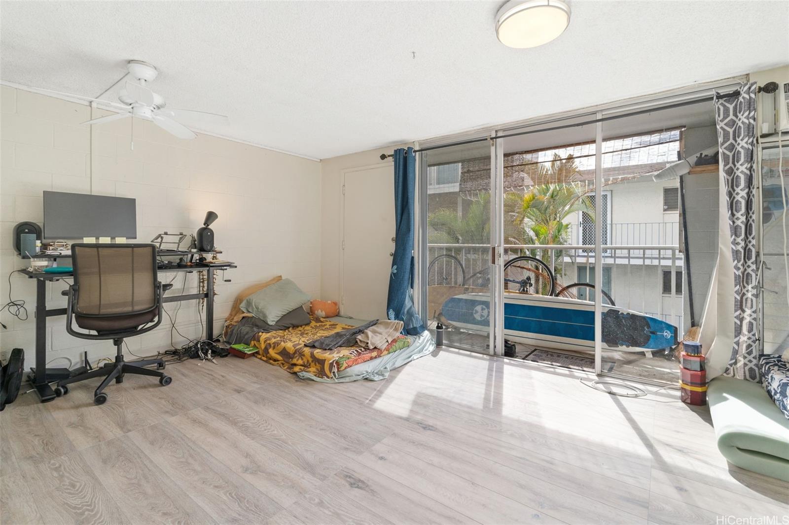 1025 Maunaihi Place, Unit 206 Honolulu, HI 96822 - Photo 6 of 9 a bedroom with furniture and a window