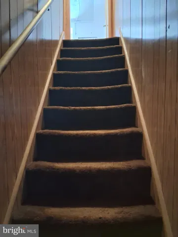 a view of a house with yard and sitting area