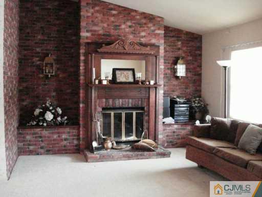 78 Harmon Road Edison, NJ 08837 - Photo 3 of 8 a living room with furniture and a fireplace