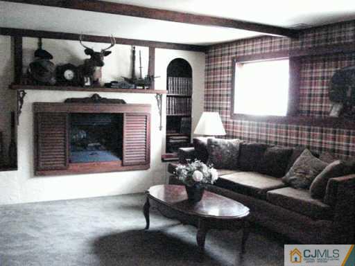 78 Harmon Road Edison, NJ 08837 - Photo 6 of 8 a living room with furniture and a fireplace