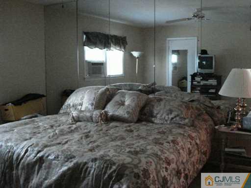78 Harmon Road Edison, NJ 08837 - Photo 7 of 8 a bedroom with a bed and window