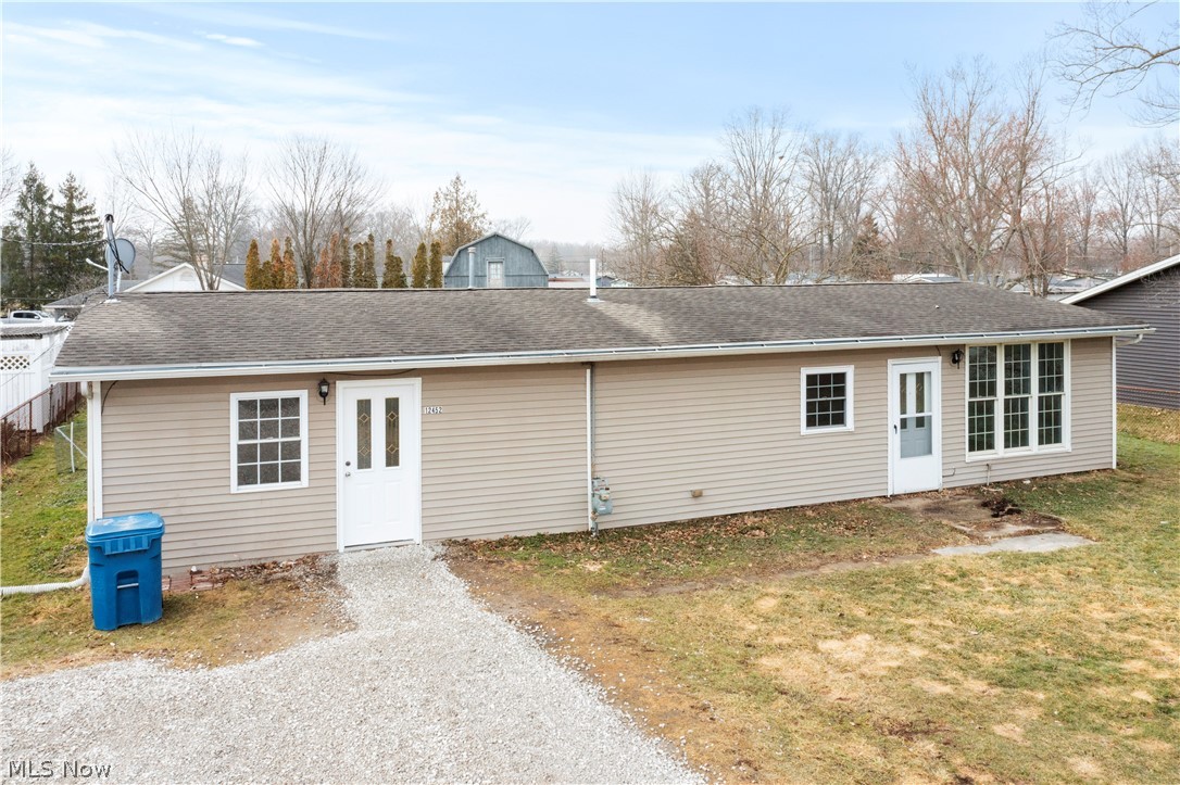12452 Island Road Grafton, OH 44044 - Photo 2 of 39 Rear view of property featuring roof with shingles and a yard