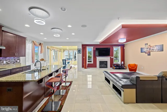 a kitchen with kitchen island granite countertop wooden cabinets a refrigerator and a stove