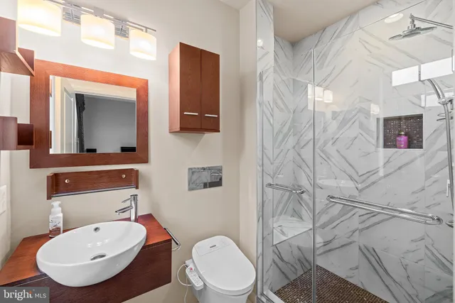 a bedroom with bed and a large window