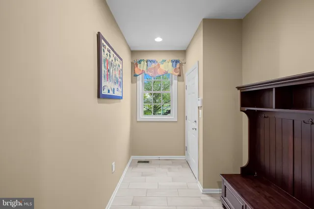 a spacious bedroom with a bed and a view of kitchen