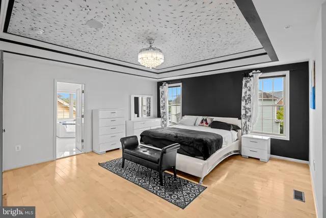 a bedroom with a bed and a dresser with rug