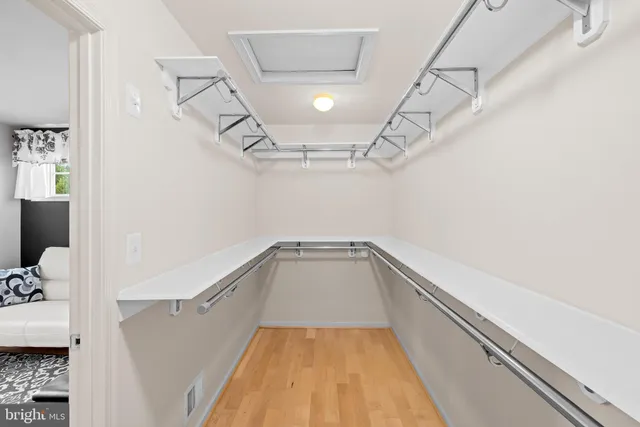 a spacious bedroom with a large bed and a flat screen tv