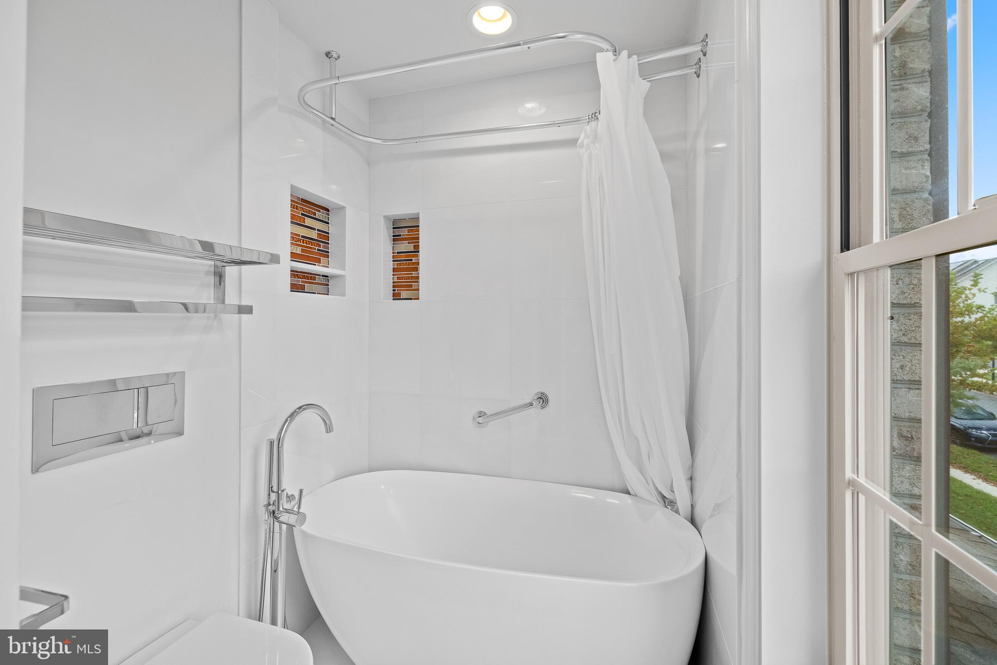 1116 Autumn Brook Avenue Silver Spring, MD 20906 - Photo 54 of 67 a white bath tub sitting next to a white toilet