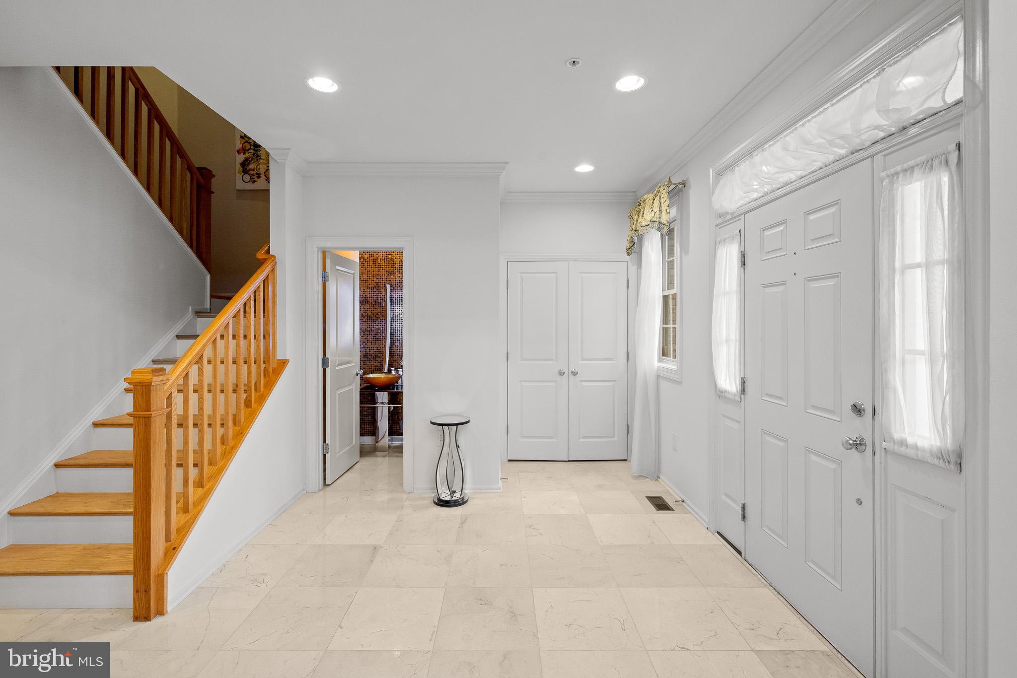 1116 Autumn Brook Avenue Silver Spring, MD 20906 - Photo 9 of 67 a view of a hallway with wooden floor and staircase