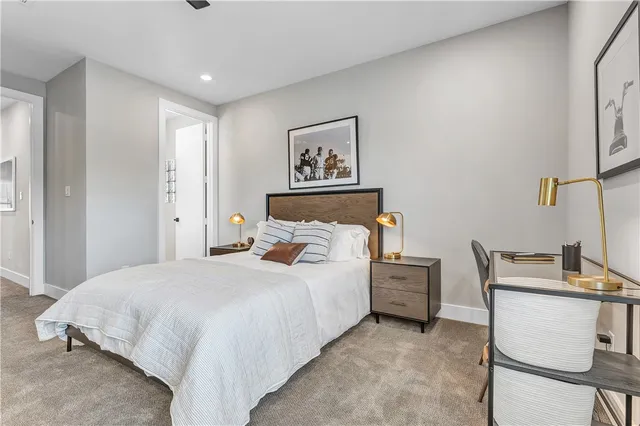 a bedroom with a bed and a painting on the wall