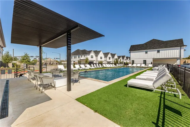 a view of a patio with a table chairs and a swimming pool