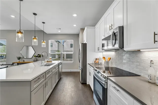 a kitchen with a sink stove and cabinets