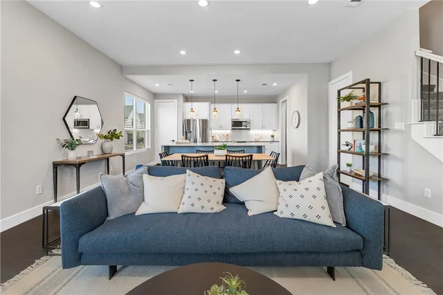 a living room with furniture and a wooden floor