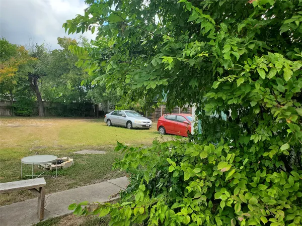 a backyard of a house with table and chairs