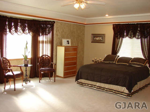 2524 I Road Grand Junction, CO 81505 - Photo 5 of 25 a bedroom with a bed and chair