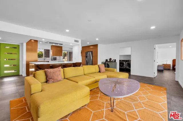 a living room with fireplace furniture and a wooden floor